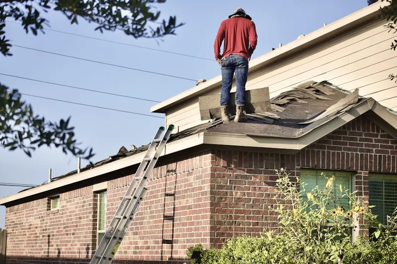 Professional roofer working on a residential roof in Cranberry Woods